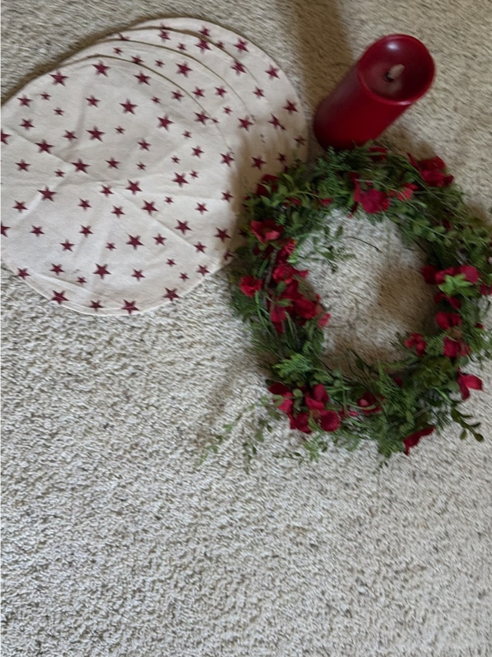 Festive Red Floral Wreath with Star-Printed Place Mats and Red Candle